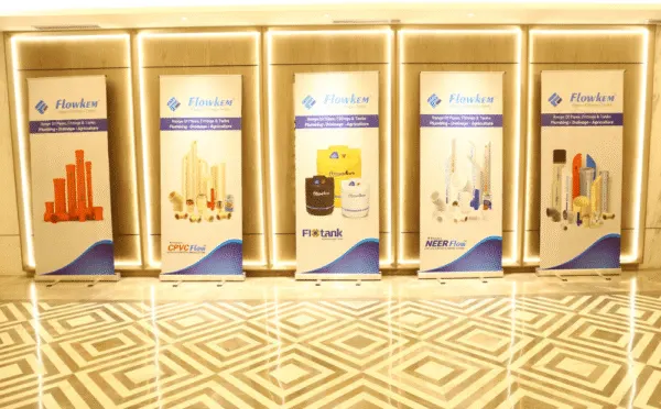 Outdoor advertising agency-designed product standees for Flowkem pipes and tanks displayed at corporate event.