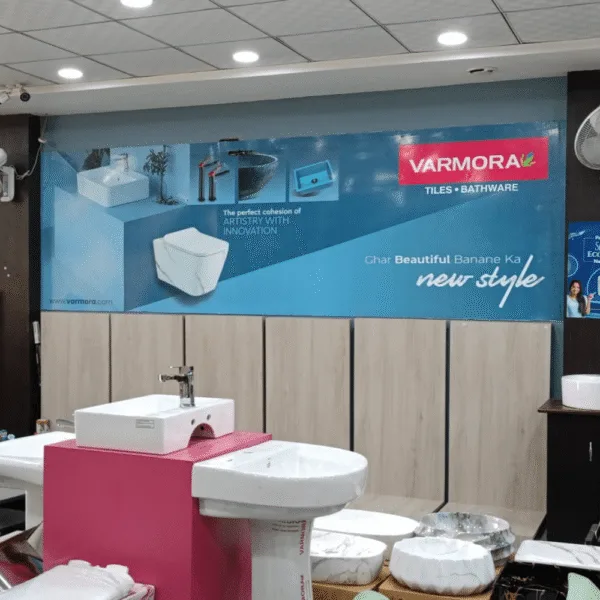 Outdoor advertising agency creative showroom branding for Varmora tiles and bathware with modern product display and promotional banner.